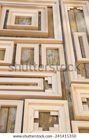 Plain wooden frames on a grunge painted background