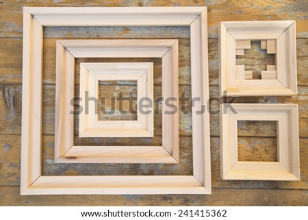 Plain wooden frames on a grunge painted background