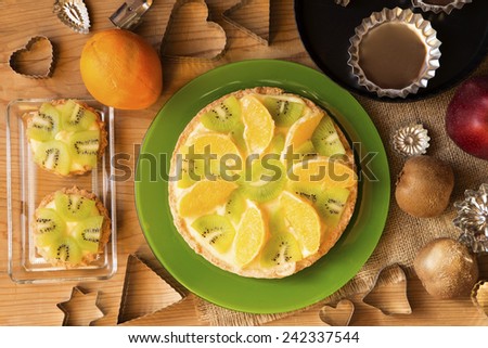Fruit tarts,  fresh fruit  and molds on a wooden background