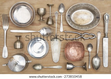 Vintage kitchen silverware  and utensils on a wooden background