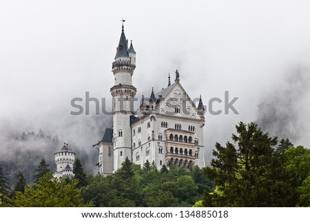 Neuschwanstein Castle cloaked in mist in Bavaria , Germany.