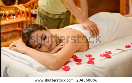 Beautiful brunette woman taking chinese massage in SPA salon