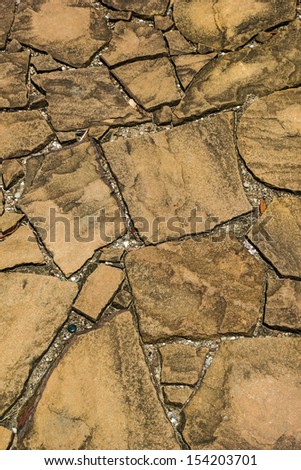 Brown sandstone  is ground and walkways.