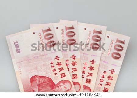 four  piece of one hundred dollar of  New Taiwan Dollar cash close up with  gray background