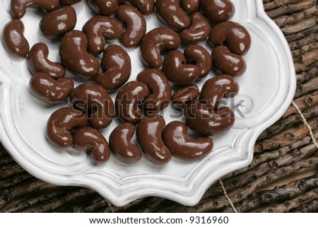 Yummy plate of chocolate covered cashew nuts for sharing or just one.