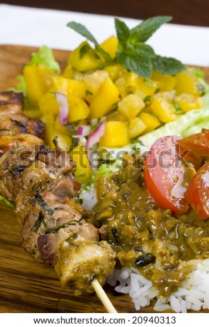 Fresh grilled chicken kebab with mango salsa and curry