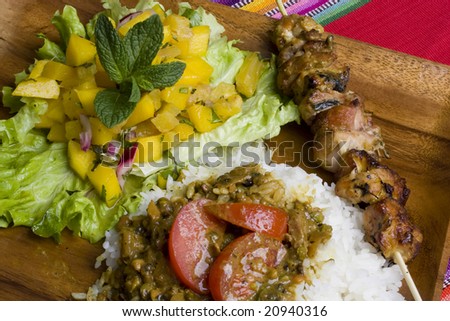 Fresh grilled chicken kebab with mango salsa and curry