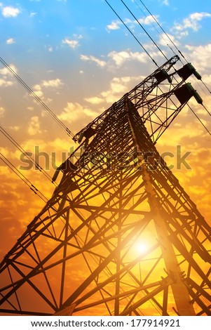 electricity pylons and lines at dusk
