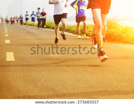 People running fast in a city marathon on street