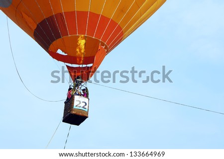 PUTRAJAYA, MALAYSIA - MARCH 29 : Unidentified visitors take the opportunity to fly with the balloon at 5th Putrajaya International Hot Air Balloon Fiesta on March 29, 2013 in Putrajaya, Malaysia.