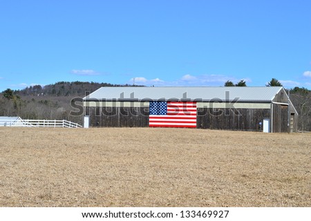 Old farm with an American flag painted on the side