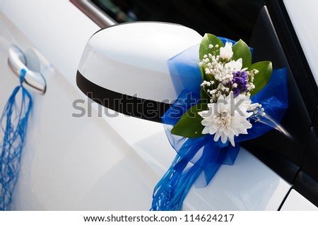 Wedding car decoration with flowers and ribbons