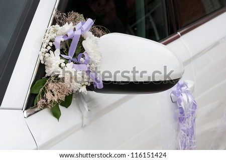Wedding car decoration with flowers and ribbons