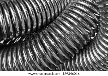Coiled metal spring abstract background close up