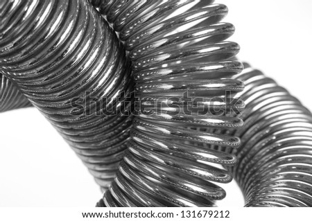 Coiled metal spring abstract background close up isolated