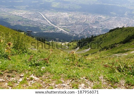panorama view of the city of Innsbruck and alpine meadow taken from 1905 m above city level