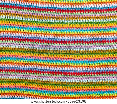 Beautiful, rainbow knitted crochet striped background. Knitted texture.