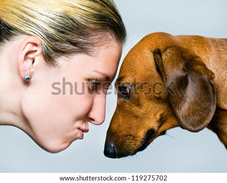 Girl and dog watching on each other