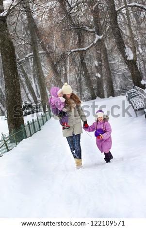 Family walk in a winter park