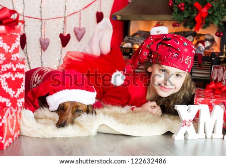 Girl with dog in christmas costumes