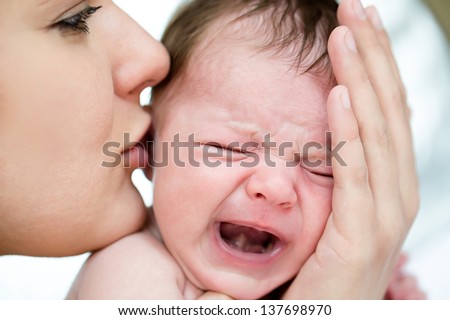 Mom soothes a crying baby Mom soothes a crying baby