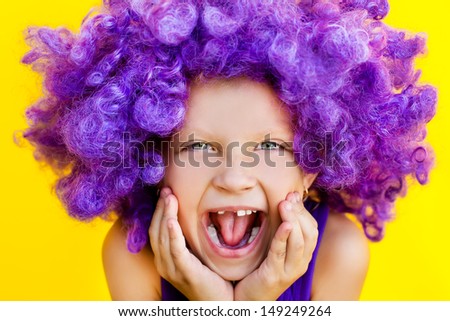 Lovely girl in a purple wig showing happy emotions