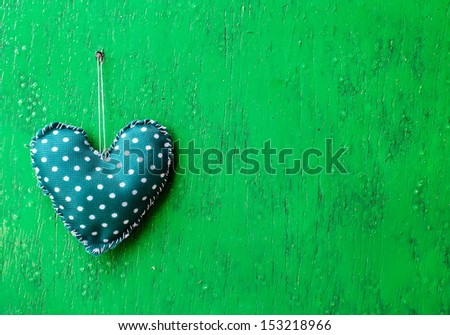 Beautiful toy\'s heart on the woody background