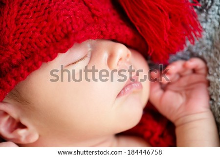 The Sweet dream cute baby in a red hat