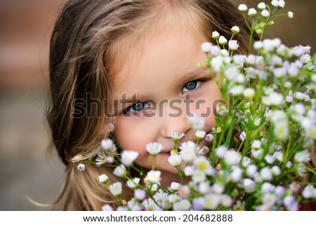 Girl with the flowers smiling on a camera
