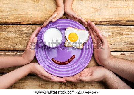 Cute breakfast with milk, jam and egg in a heart shape for the whole family