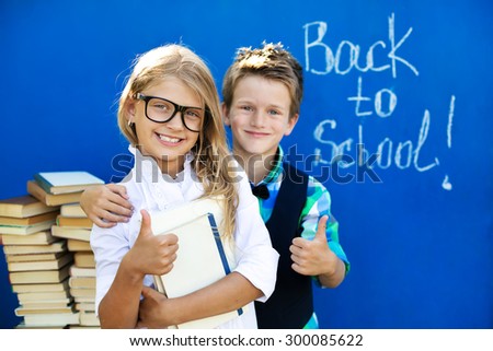 The brother and sister with the books are preparing to the new school year