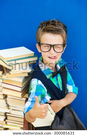 The boy with the books preparing to the new school year