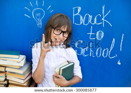 The girl with the books preparing to the new school year