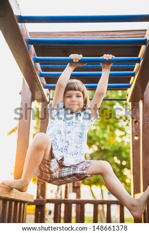 Boy hanging on the ladder. summer  photo-shoot