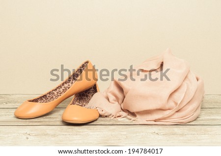 Ballerina shoes and scarf on wooden board