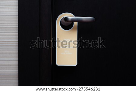 Do not disturb sign handle on a hotel door, close up