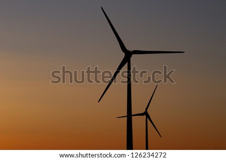 Wind turbines-Silhouette of two wind turbines in a red sunset