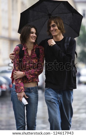 Young couple walking in rain