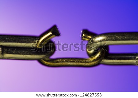 Closeup of broken chain on colored background