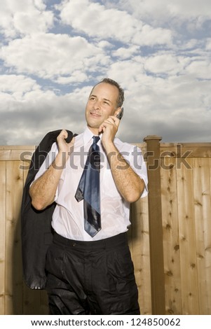 Businessman in wet suit talking on phone