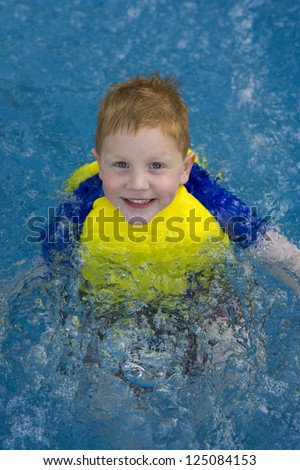 Little boy posing in swimming pool