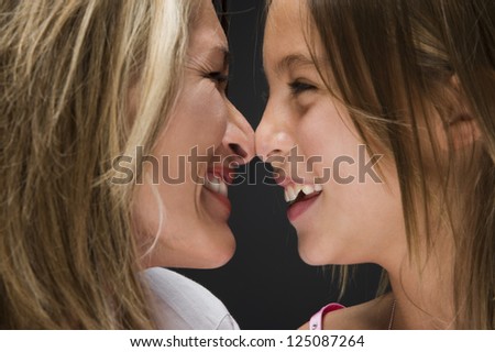 Portrait of mother and daughter rubbing noses