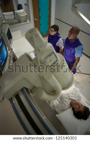 High angle view of a woman undergoing x-ray in lab