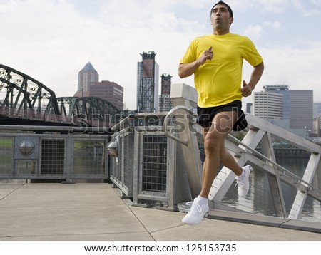 Male jogger in the city while running