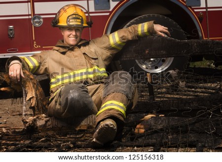 Young female fire fighter having rest