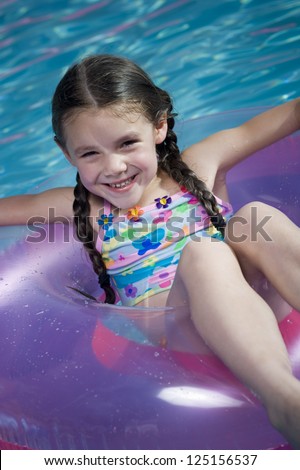 Young girl in swim ring in a swimming pool
