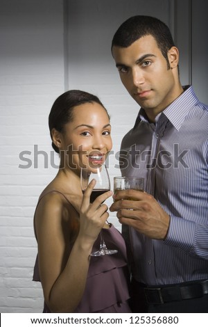 Young couple having drinks at a party
