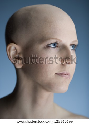 Profile view of a young bald woman