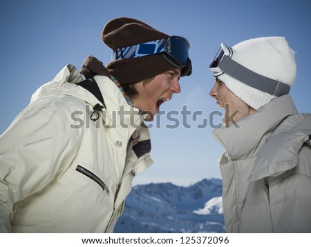 Two people arguing in ski clothing