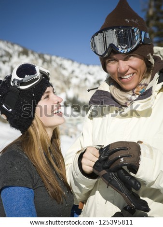 Portrait of smiling couple wearing hat and ski goggles